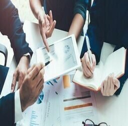 Asian business adviser meeting to analyze and discuss the situation on the financial report in the meeting room.Investment Consultant,Financial Consultant,Financial advisor and accounting concept